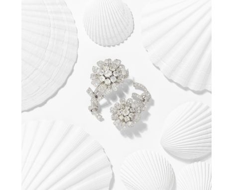 TWO DIAMOND FLOWER BROOCHES, CIRCA 1960Each designed as a flower, the petals and stem set with cushion and old brilliant-cut 