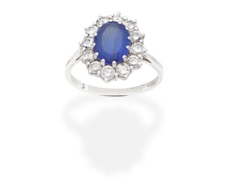 TANZANITE AND DIAMOND CLUSTER RINGThe oval-cut tanzanite within a brilliant-cut diamond surround, diamonds approx. 1.20cts to