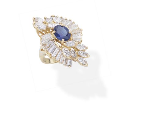 SAPPHIRE AND DIAMOND DRESS RINGThe oval-cut sapphire within a surround of marquise and tapered baguette-cut diamonds, diamond