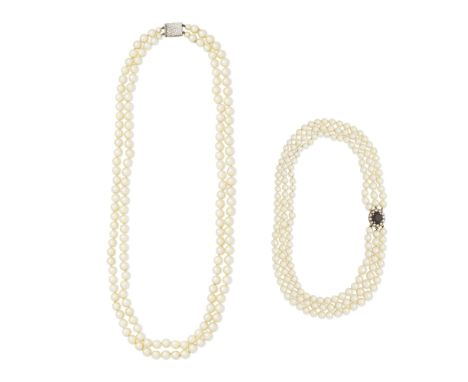 TWO CULTURED PEARL NECKLACES1st: The three row 5.0-9.0mm cultured pearl necklace, on a garnet and pearl clasp of cluster desi