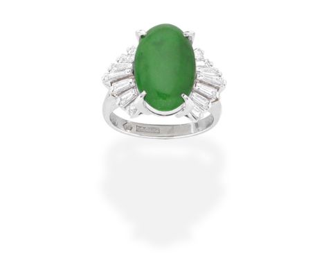 JADE AND DIAMOND RINGThe oval jadeite jade cabochon, set between radiating tapered baguette-cut diamond shoulders, diamonds a