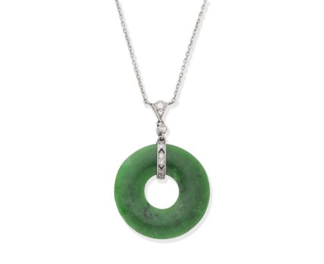 JADE AND DIAMOND NECKLACEThe jade disc suspended from a single and brilliant-cut diamond surmount, on a trace-link chain with