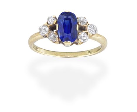 SAPPHIRE AND DIAMOND RINGThe oval-cut sapphire set between trios of cushion-shaped diamonds, ring size approx. KFootnotes:Ple