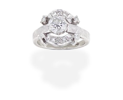 DIAMOND RINGSet with a brilliant-cut diamond, within a single-cut diamond surround, the shoulders of engine-turned finish, pr
