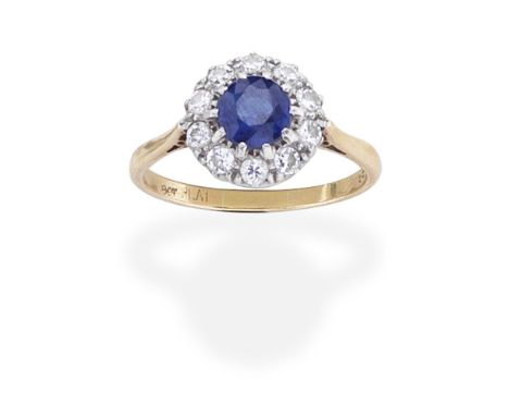 SAPPHIRE AND DIAMOND CLUSTER RINGThe circular-cut sapphire within a surround of brilliant-cut diamonds,  ring size approx. S½