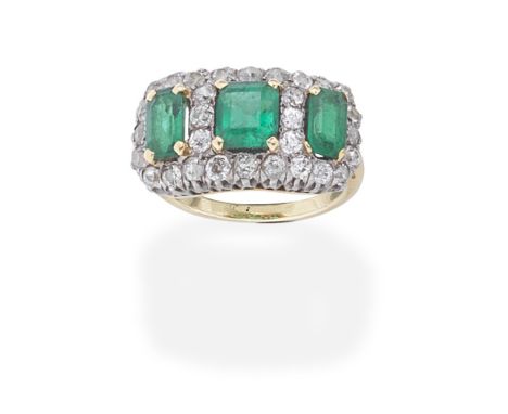 EMERALD AND DIAMOND RINGSet with three step-cut emeralds within a cushion-shaped diamond surround,  ring size approx. KFor fu