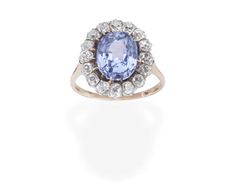 SAPPHIRE AND DIAMOND CLUSTER RINGThe oval-cut sapphire within a surround of cushion-shaped diamonds, diamonds approx. 0.80ct 