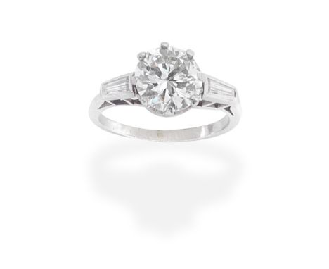DIAMOND SINGLE-STONE RINGSet with a brilliant-cut diamond, weighing 2.16 carats, between tapered baguette-cut diamond shoulde
