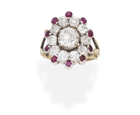 DIAMOND AND RUBY PLAQUE RINGSet with a cushion-shaped diamond within a similarly-cut diamond and circular-cut ruby surround, 
