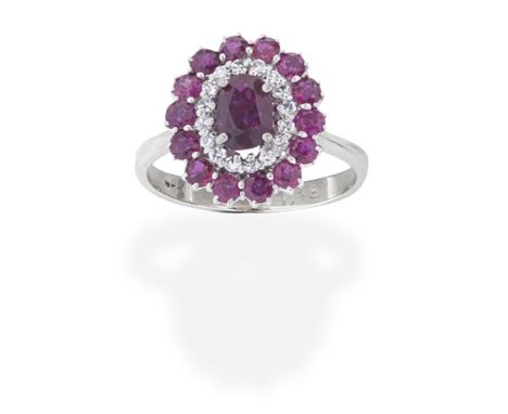 RUBY AND DIAMOND CLUSTER RINGThe cushion-shaped ruby within a surround of single-cut diamonds and circular-cut rubies, ring s