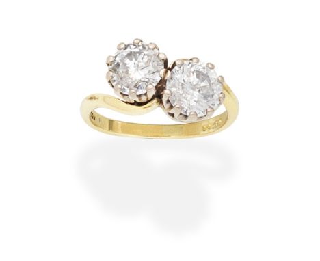 DIAMOND TWO-STONE RINGOf crossover design, set with two brilliant-cut diamonds, mounted in 18 carat gold, diamonds approx. 3.