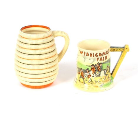 A Clarice Cliff Newport pottery mug of ribbed design with black and orange line decoration, 16cm high; and an Fielding's Crow