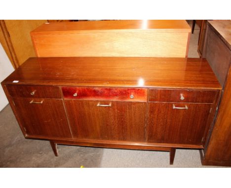 A dark teak sideboard, fitted three drawers above cupboards and drop flap central compartment raised on square tapering suppo
