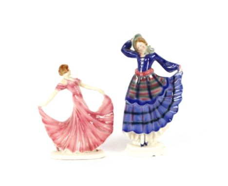 An Art Deco porcelain figural mirror; a porcelain hat pin holder in the form of a lady wearing a fur coat; two Art Deco porce