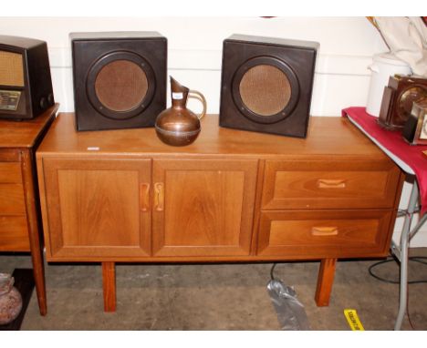 A teak G-plan design sideboard fitted two drawers and a double cupboard, raised on square section supports 131cm wide x 70cm 