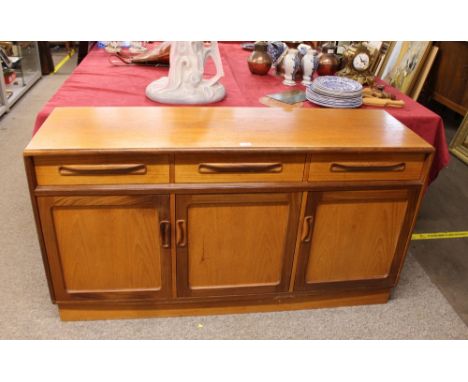 A G-plan design teak sideboard, fitted three drawers and cupboards below, raised on a platform plinth 142cm wide x 44cm deep 