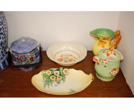 An Art Deco Burleigh ware jug with fox handle; a Royal Winton biscuit barrel; a Ruskin Art pottery biscuit barrel with wicker