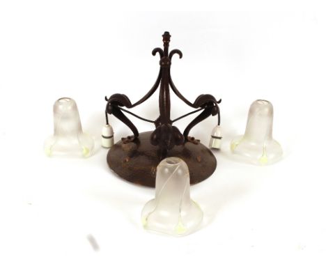 An Art Nouveau spot hammered coppered light fitting of foliate scrolled form, complete with three opalescent glass shades of 