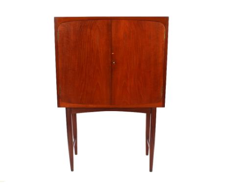 A Maple teak drinks cabinet, the interior glass shelves and drawers raised on square section and rounded tapering supports un