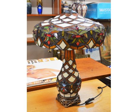 An Art Deco style Tiffany type table lamp, with foliate decoration to the shade