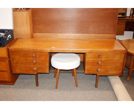 A teak kneehole dressing table, fitted six drawers and raised on square section supports 163cm wide x 64cm high x 44cm deep; 