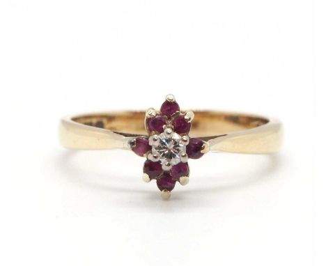 A 9ct ruby and diamond cluster ring, the central round brilliant cut diamond surrounded by small round rubies, with plain ban