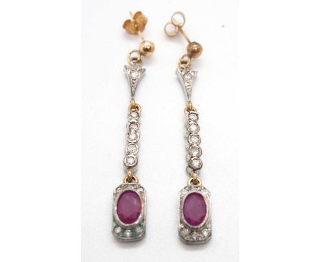 A pair of Art Deco style ruby and diamond earrings, the oval mixed cut rubies, collet mounted within a rectangular frame set 
