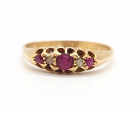 An 18ct ruby ring, the three round graduated rubies interspaced with a single rose cut diamond to each side, with raised gall
