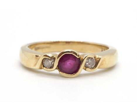 A 9ct ruby and diamond ring, the round collet mounted ruby with a round brilliant cut diamond to either side, with plain band