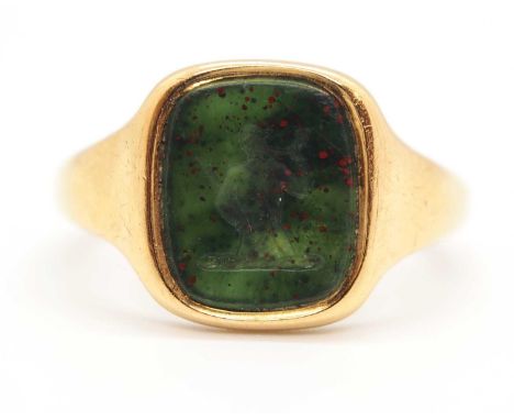 An 18ct bloodstone intaglio signet ring, the bloodstone panel with intaglio of a huntsman and horn, collet mounted with taper