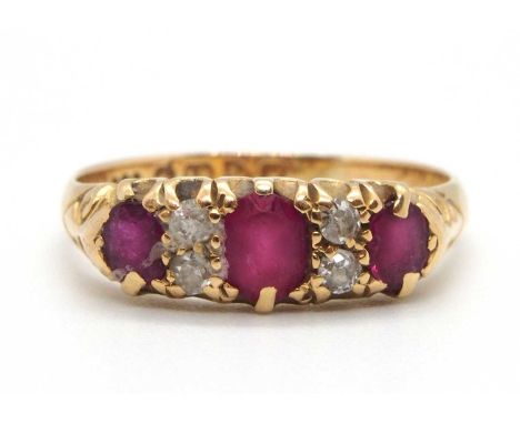 An early 20th century ruby and diamond ring, set with three graduated rubies interspaced with two small round diamonds, with 