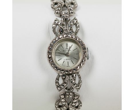 LADY'S FINE SILVER MARCASITE BUCHERER COCKTAIL WATCH
unsigned seventeen jewels manual wind movement, the silvered dial with b