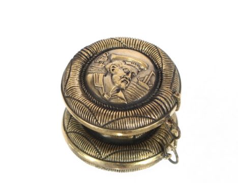 A circular brass snuff box with sailor decoration 