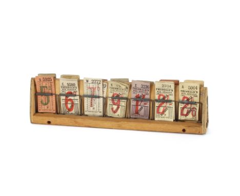 A mid 20th Century bus ticket holder and quantity of used and unused tickets