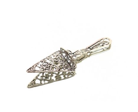 A white metal book mark in the form of a trowel