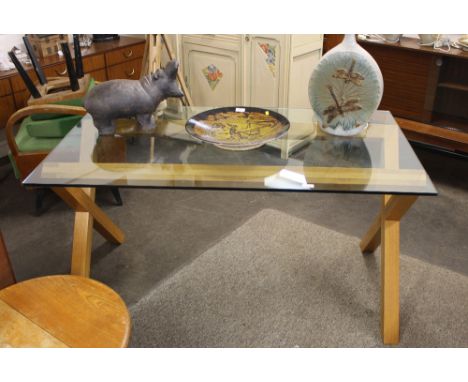 A Habitat light oak cross framed dining table with plate glass top, 140cm x 80cm