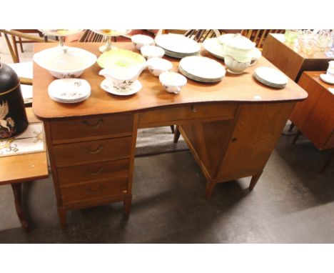 A Danish teak pedestal desk, fitted drawers and cupboard raised on square section supports, 130cm wide 