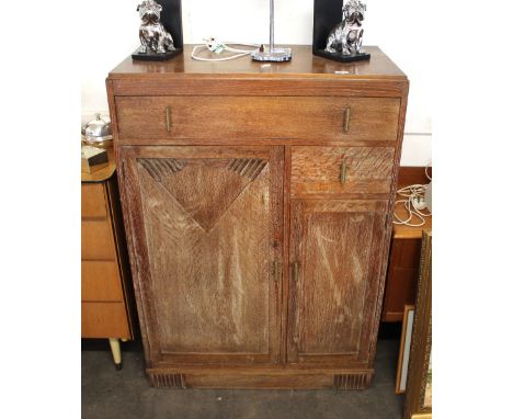 An Art Deco limed oak tallboy, fitted with an arrangement of drawers and cupboards, 85cm wide