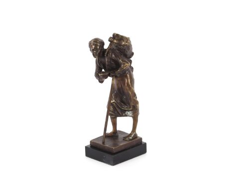 A bronze figure of an Arab street vendor, raised on a marble plinth base, 25cm high