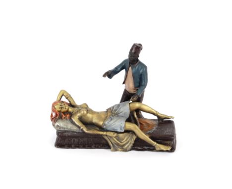 A bronze figure group depicting an Arab and reclining nude