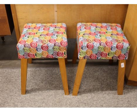 A pair of light oak stools, upholstered in bold coloured swirling moquette