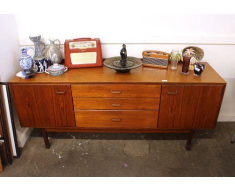 A teak Macintosh design sideboard fitted three central drawers flanked by cupboard, raised on square section supports, 167cm 