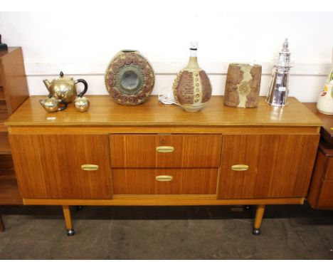 A teak effect G plan style sideboard, fitted two central drawers flanked by cupboards, raised on tapering square section supp