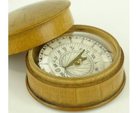 A treen cased compass, diameter 5.5cm