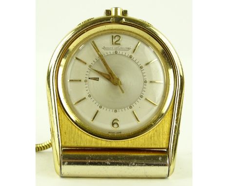 A gold plate Jaeger Le Coultre travelling alarm clock, on plated tie clip Albert, case no. 709689, case width 37mm, working o