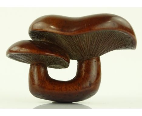 A Japanese Meiji period carved wood mushroom design netsuke, length 4cm