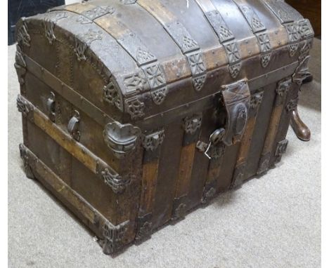 A 19th century American wood and metal bound domed top travelling trunk, the interior fitted with inner trays and compartment