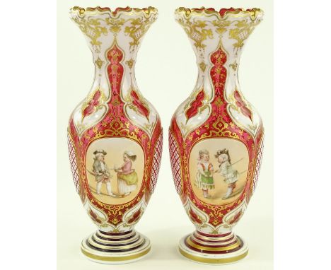 A pair of ornate 19th century Bohemian ruby overlay glass vases, hand painted panels depicting children in costume, painted b