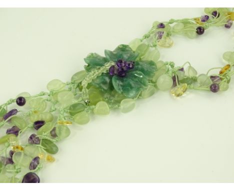 A carved jade amethyst and semi precious stone multiple strand necklace, with jade flowerhead pendant below.