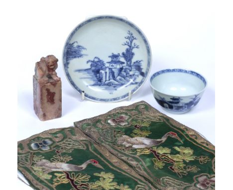 Blue and white tea bowl and saucer Chinese, 18th Century from the Nanking Cargo two small Chinese silk panels and a soapstone